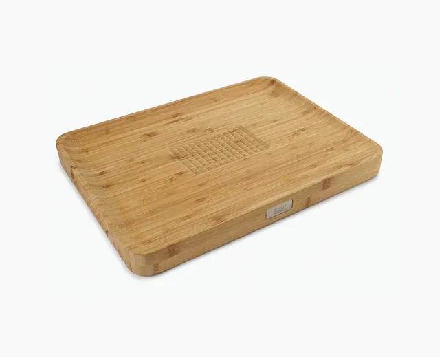 joseph-joseph-cut-carve-bamboo-chopping-board-with-integrated-food-grip image 1